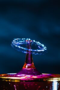 A close-up of a water droplet bouncing on the surface of a mushroom cap.