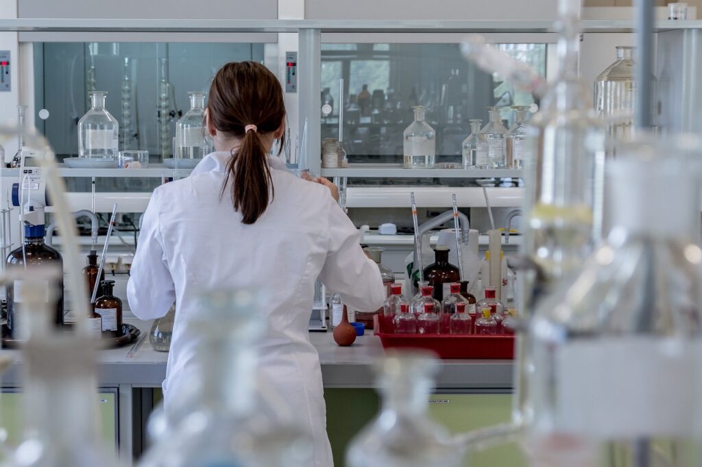 Image of a mycologist studying mushroom spore genetics in a laboratory setting